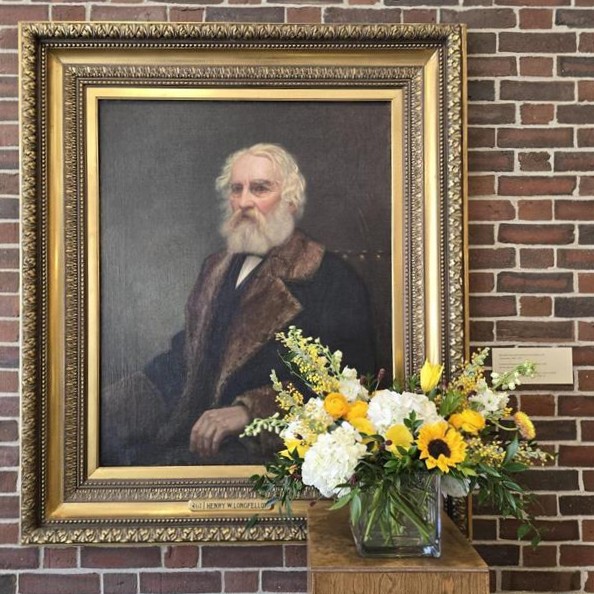 Portrait of Henry Wadsworth Longfellow with a bouquet of yellow and white flowers