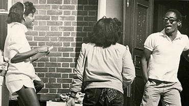 Undated. Candid shot of students selling concert tickets at the entrance of Moulton Union.