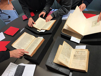 students looking at books